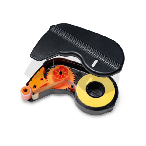 Ein Korrekturroller mit einem schwarzen Gehäuse und sichtbarem inneren Mechanismus in orange und gelb.